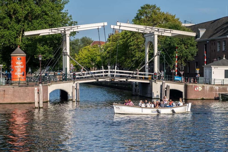 Amsterdam: 75 minute Open Boat Canal Cruise with Live Guide - The Museum Quarter, Heineken Experience, and the return route