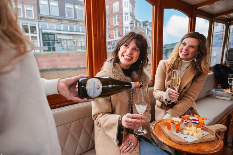 Amsterdam: Canal Cruise with Bubbles & Bites - Boarding the covered boat