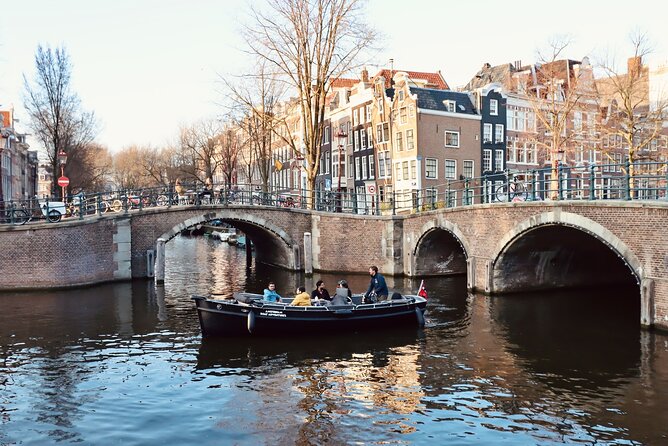 Amsterdam Canal Tour by Open Boat – 90 min Small Group Experience - Medieval locks, warehouses, and Nieuwmarkt