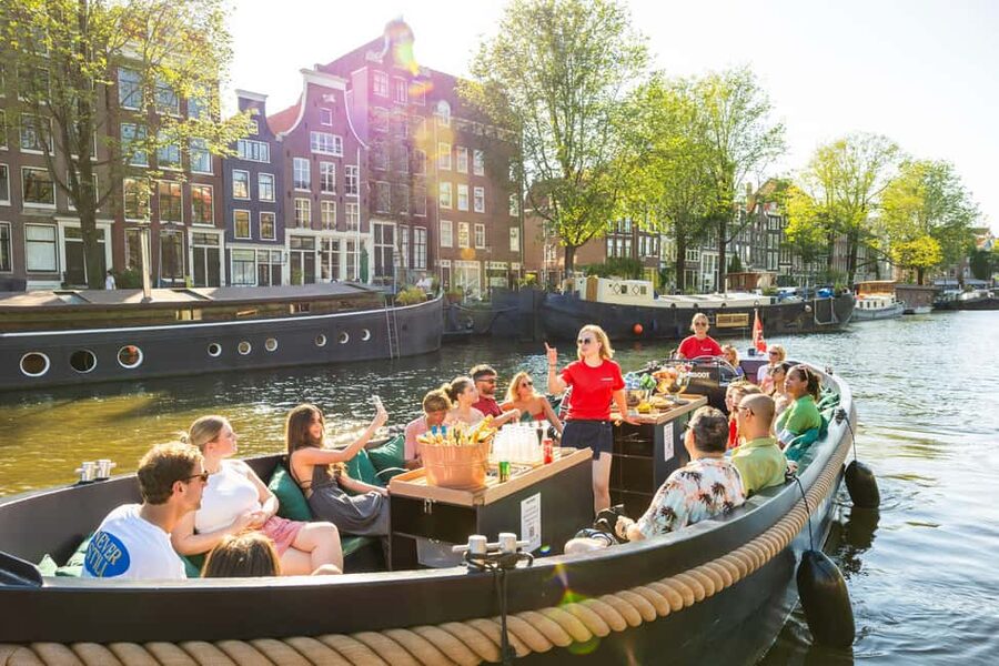 Amsterdam: Guided Open Boat Canal Cruise Including Drink - Meeting at Amsterdam Centraal and settling aboard