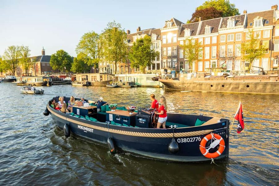 Amsterdam: Guided Open Boat Canal Cruise Including Drink - Weather, comfort, and what to bring