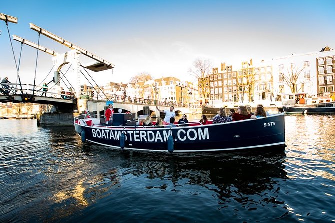 Amsterdam Open Boat Cruise with Live Guide and Two Drinks - Smaller museums, unusual buildings, and the eastern route