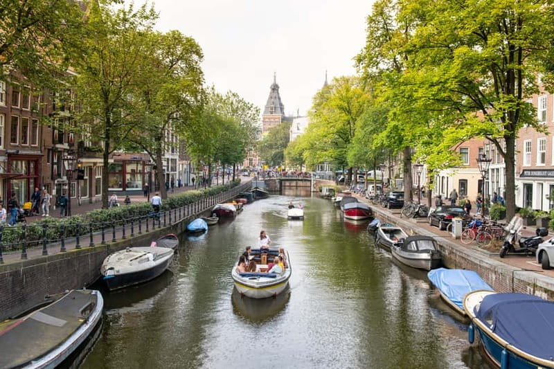 Amsterdam: Open Boat Tour of Canals with Expert Local Guide - Passing Amsterdam Centraal Station by water