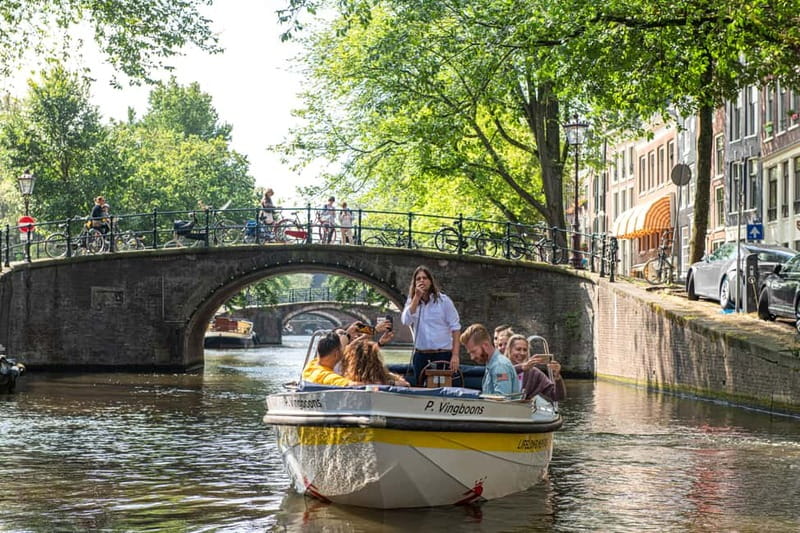 Amsterdam: Open Boat Tour of Canals with Expert Local Guide - Starting at Damrak, the city’s easy first chapter