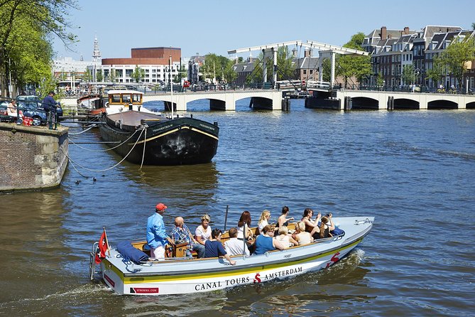 Amsterdam Open Boat Tour with Local Guide - Open boat comfort, clothing, and weather
