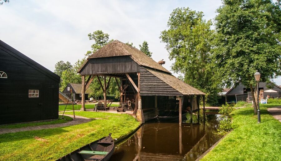 Giethoorn: Private Day Trip with Boat Tour from Amsterdam - Walking into Giethoorn’s canal village