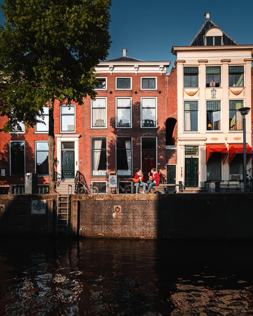 Groningen: Informative city canal cruise + drinks & cookies - Historic warehouses and working waterfront views