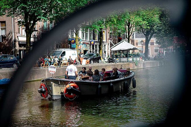 Guided Amsterdam Canal Cruise – Snacks & Drinks on board(1 Hour) - Maritime power beside the replica ship