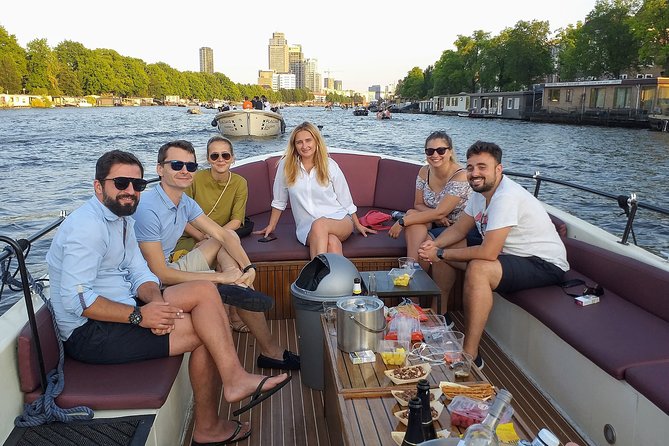 Guided Amsterdam Canal Cruise – Snacks & Drinks on board(1 Hour) - Starting among Amsterdam’s oldest streets