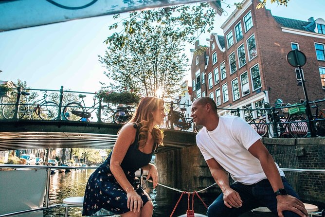 Private Romantic Canal Cruise Amsterdam with Bubbly and Snacks - Bridges, houseboats, and Amsterdam’s romantic stories