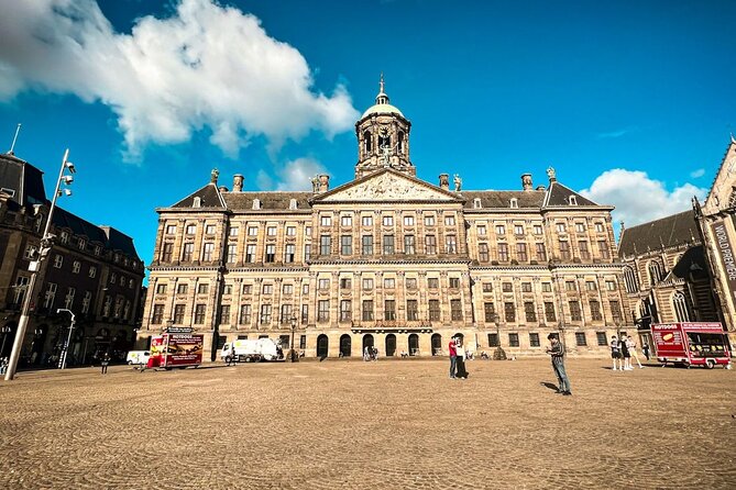 Small Group Walking Tour - Hello Amsterdam - Damrak brings facts, games, and the dancing houses